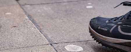 Trainer about to step on dried chewing gum in the street, copyright Keep Britain Tidy.