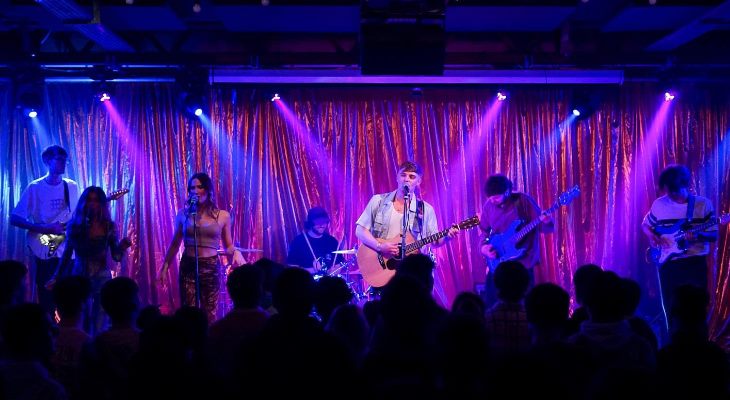 Rohan Young and band performing on stage.