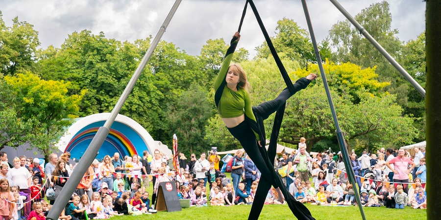 Cartwheel Arts performing in Queen's Park in Heywood.