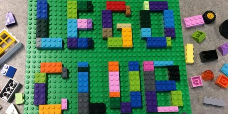 A Lego baseplate with the word Lego Club spelt out in Lego bricks.