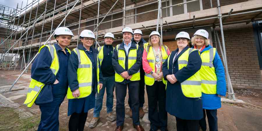 Councillors and stakeholders outside the development.
