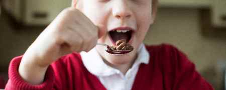 Child eating breakfast.