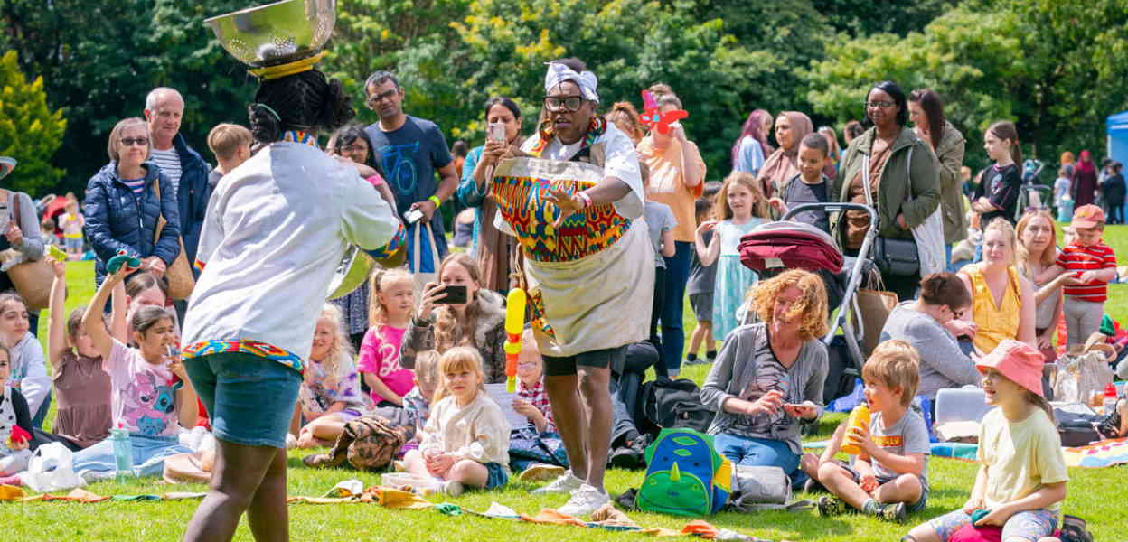 Families watching a performance of Do What Your Mamma Told Ya.