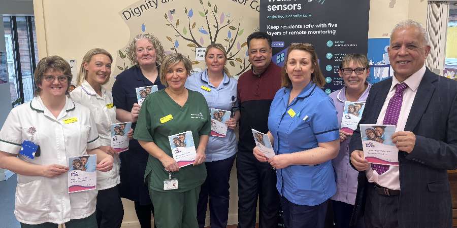 Councillors Daalat Ali and Iftikhar Ahmed with Tudor Court staff.