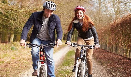 Couple cycling in autumn.