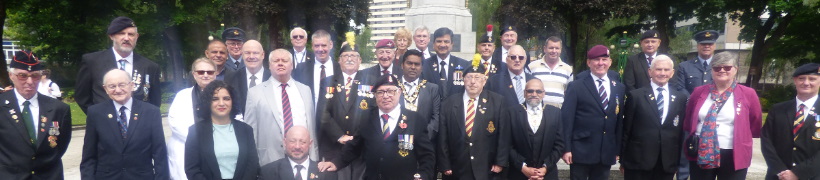 Veterans and councillors standing in front of Rochdale Cenotaph.