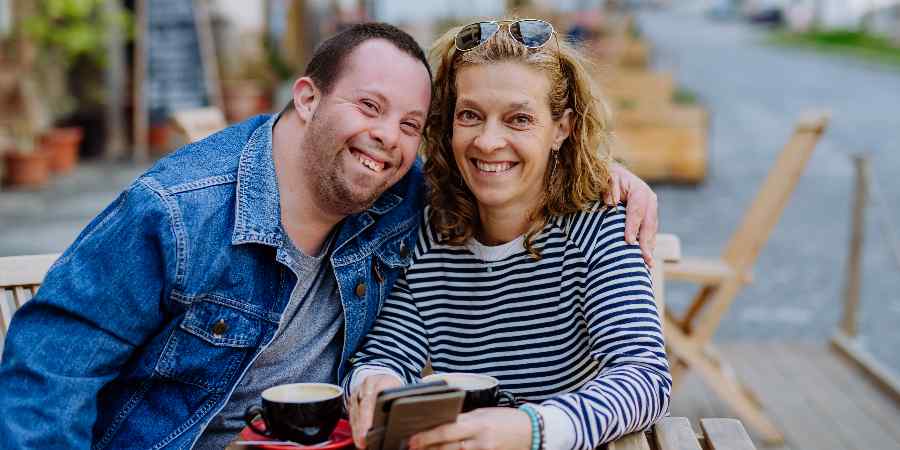 Autistic adult and carer.