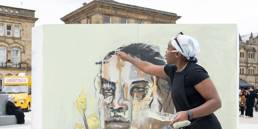 Artist working on painting.