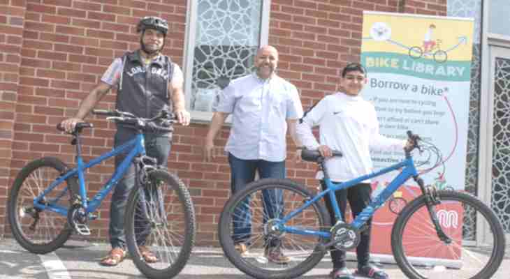 Residents standing with bikes.