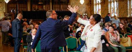 Attendees linking hands at the Co-operative Congress.