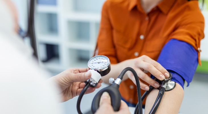 A person having their blood pressure measured.