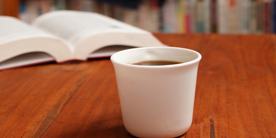 Coffee cup on a library desk.