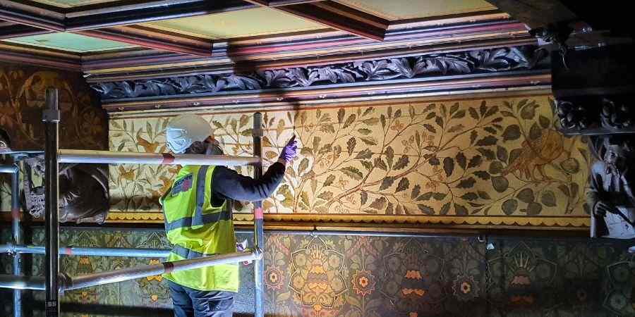 Volunteer working on wall panels.