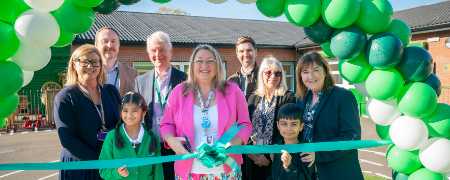 Councillor Rachel Massey and Sharon Hubber with staff and pupils at Deeplish Primary Academy.