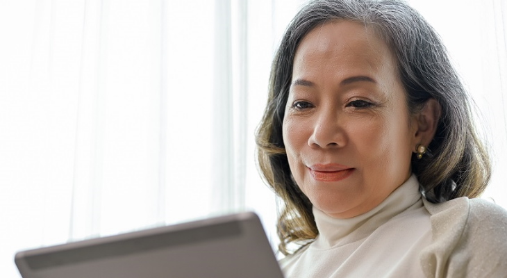 A woman using a tablet.