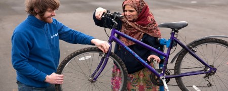 Doctor Bike checking a bicycle for a resident.
