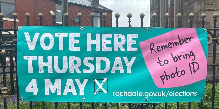 Sign saying, Vote here, 4 May, remember to bring photo ID.