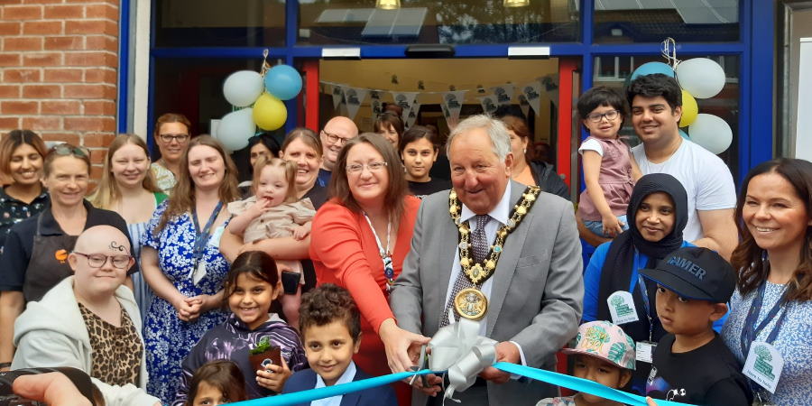 Councillors Mike Holly and Rachel Massey cutting the ribbon at the new family hub.
