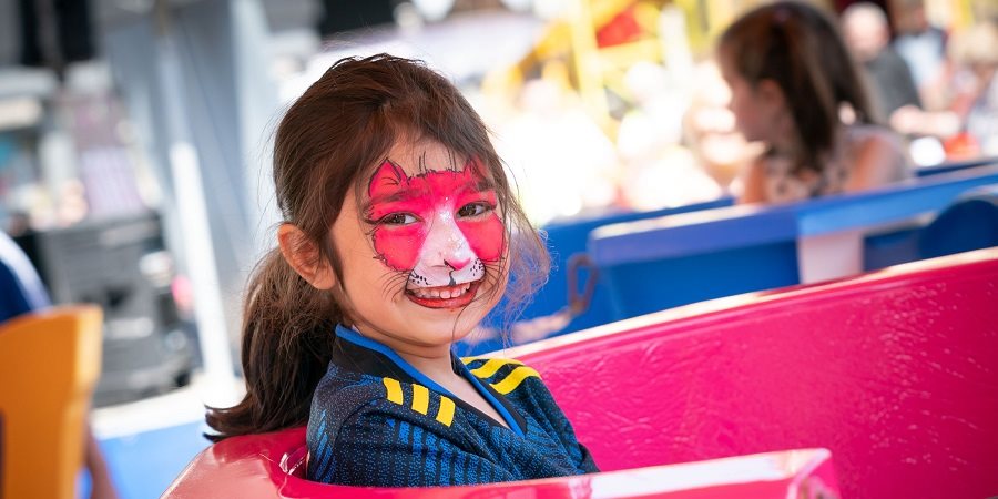 A young visitor enjoying a fairground ride at a previous Street Eat.