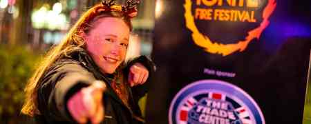 Child stood in front of Ignite-branded sign.