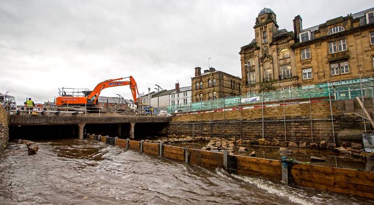 A digger working on opening the River Roch.