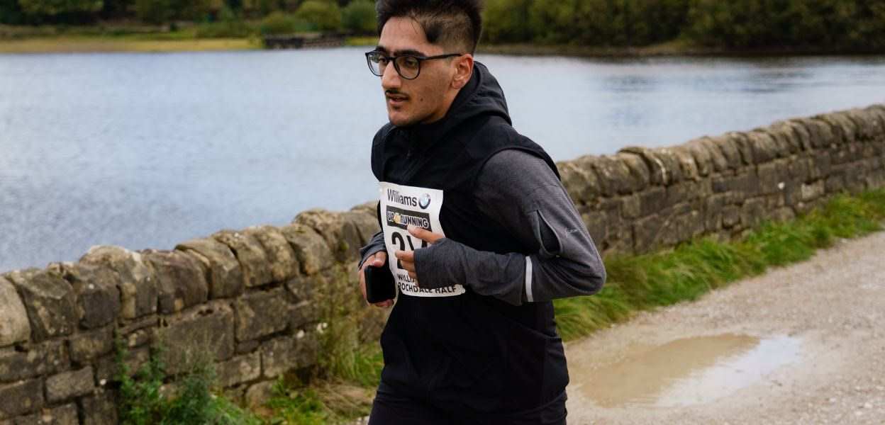 Runner in the Half Marathon running past Hollingworth Lake.