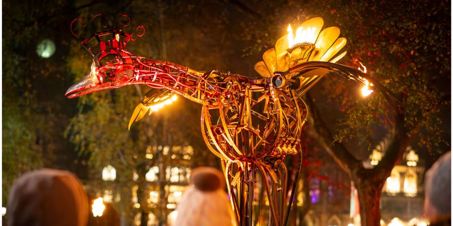 A large, intricate metal sculpture of a bird.