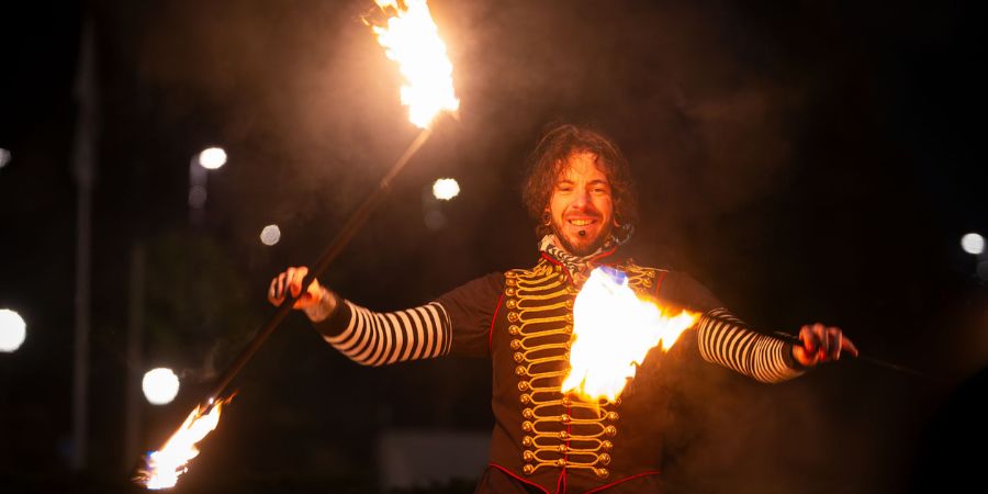 A performer juggling fire.
