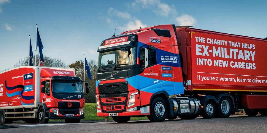 2 trucks with Veterans Into Logistics branding.