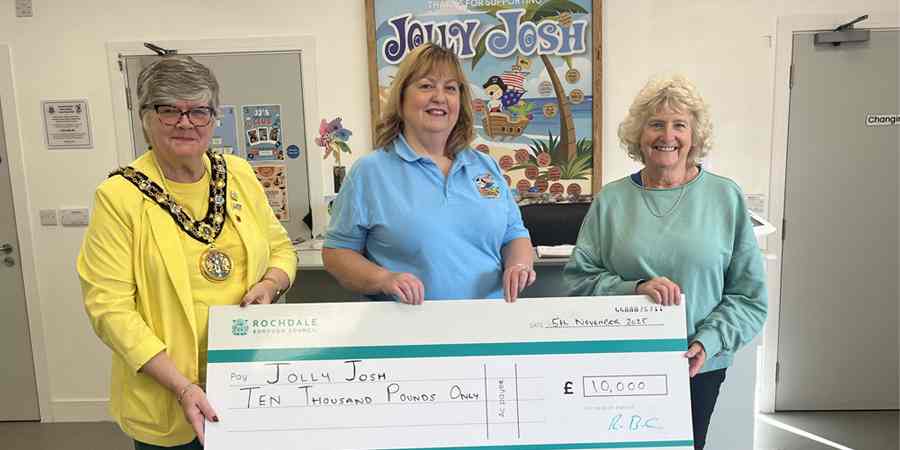 Councillor Janet Emsley, Sarah Ford and Councillor Tricia Ayrton with large cheque.