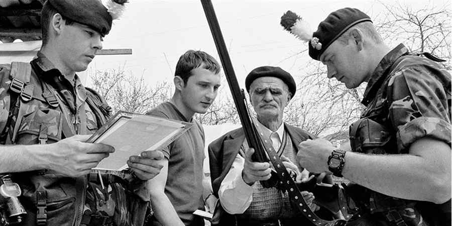 Soldier talking with civilians in Kosovo.