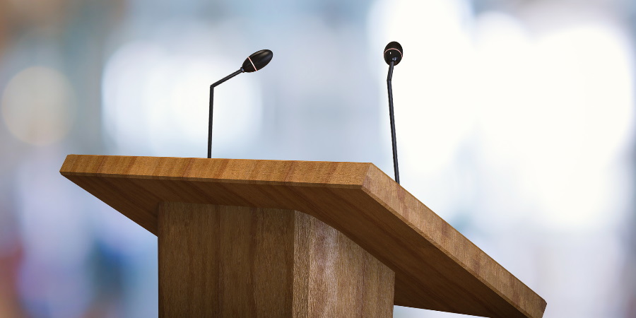 A microphone attached to a podium.