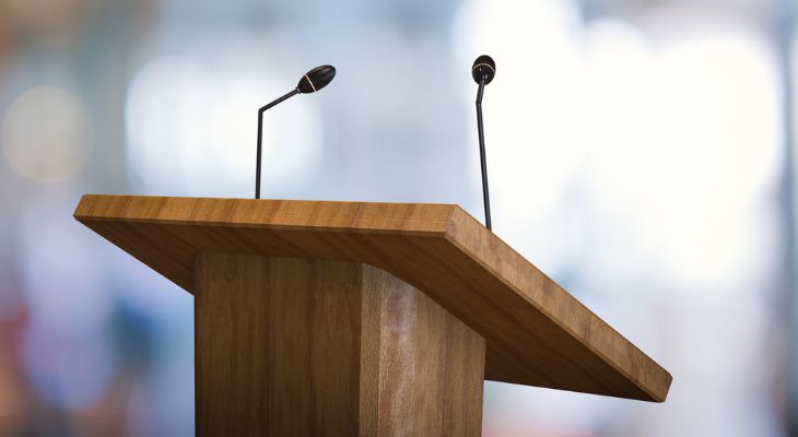 A speaker&#039;s podium with two microphones