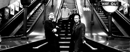 Ocean Colour Scene stood on an escalator.