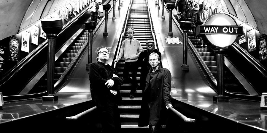 Ocean Colour Scene stood on an escalator.