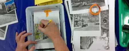 Hands working on a photo display.