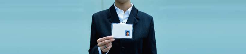 Person holding up an id card.