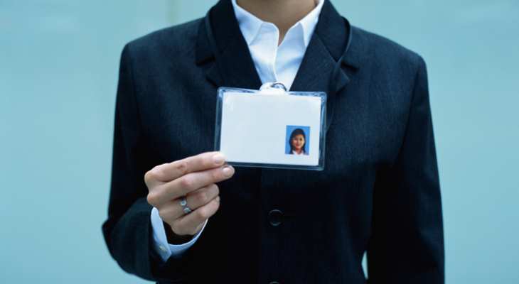 Person holding up an identity card.