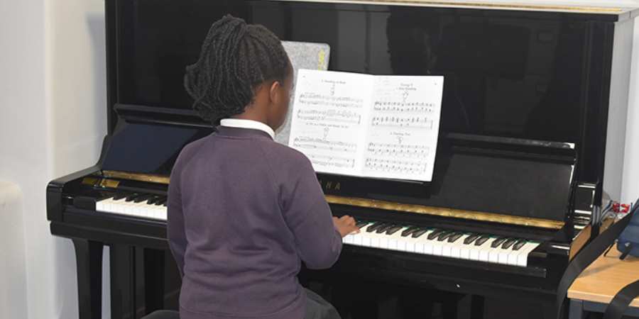 Student in a piano lesson.