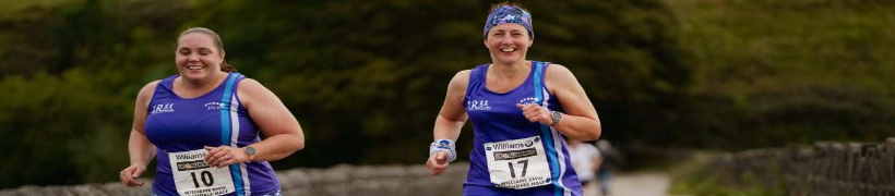 2 runners in the Half Marathon passing Hollingworth Lake.