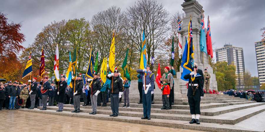 Veterans with raised flags at the Cenotaph.