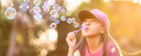 Girl blowing bubbles.
