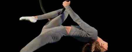 Acrobat performing an aerial hoop trick.