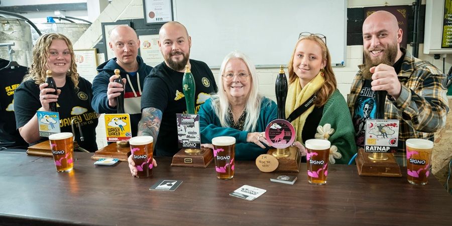 A group of people behind a bar.
