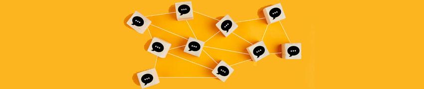 Yellow background with building blocks containing speech bubbles