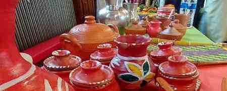 Array of colourful cooking pots.