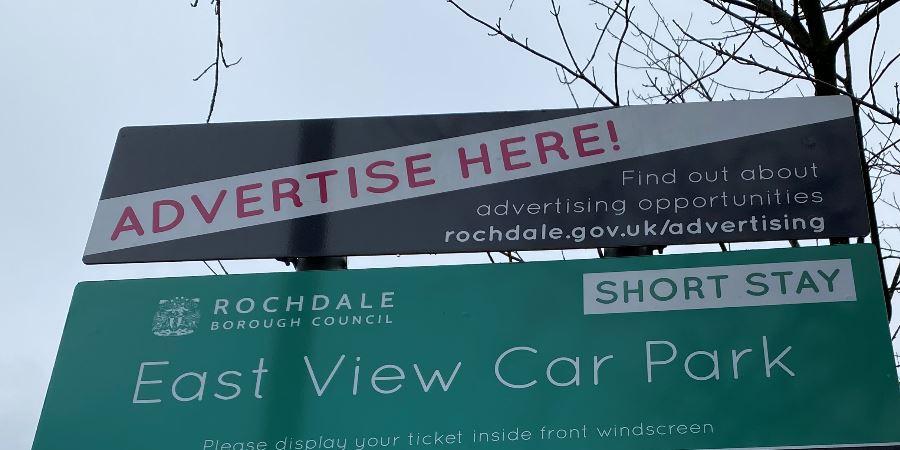 Sign saying Advertise here on top of East View car park sign.