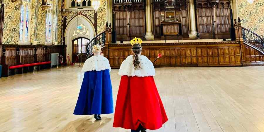 Children dressed in royal robes in the Town Halls Great Hall.