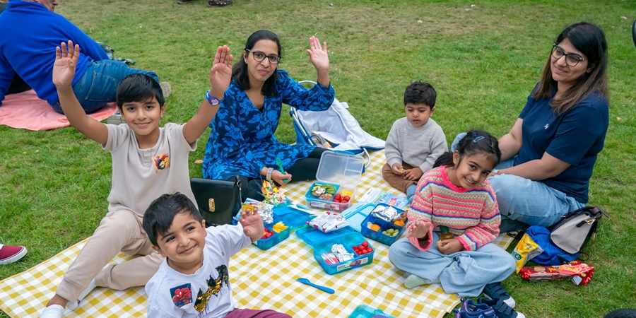 A family sat on a picnic mat.