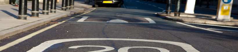 A 20mph sign in front of a speed hump.